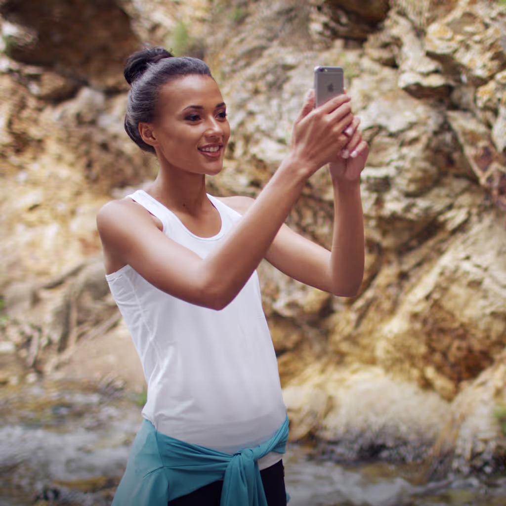 Woman holding iPhone using augmented reality